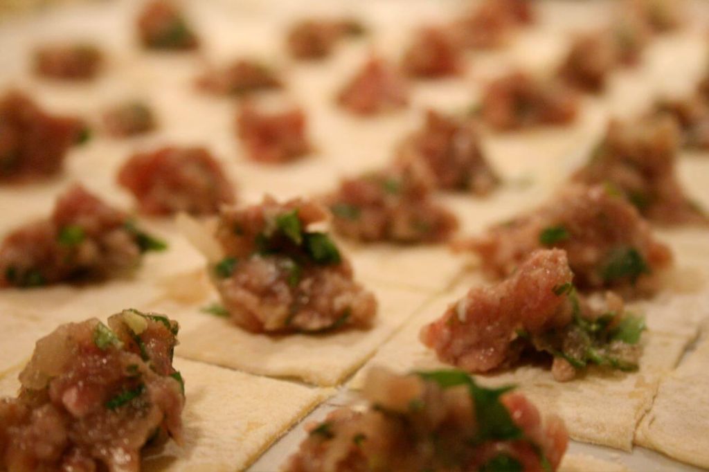 Cooking Turkish manti with spices